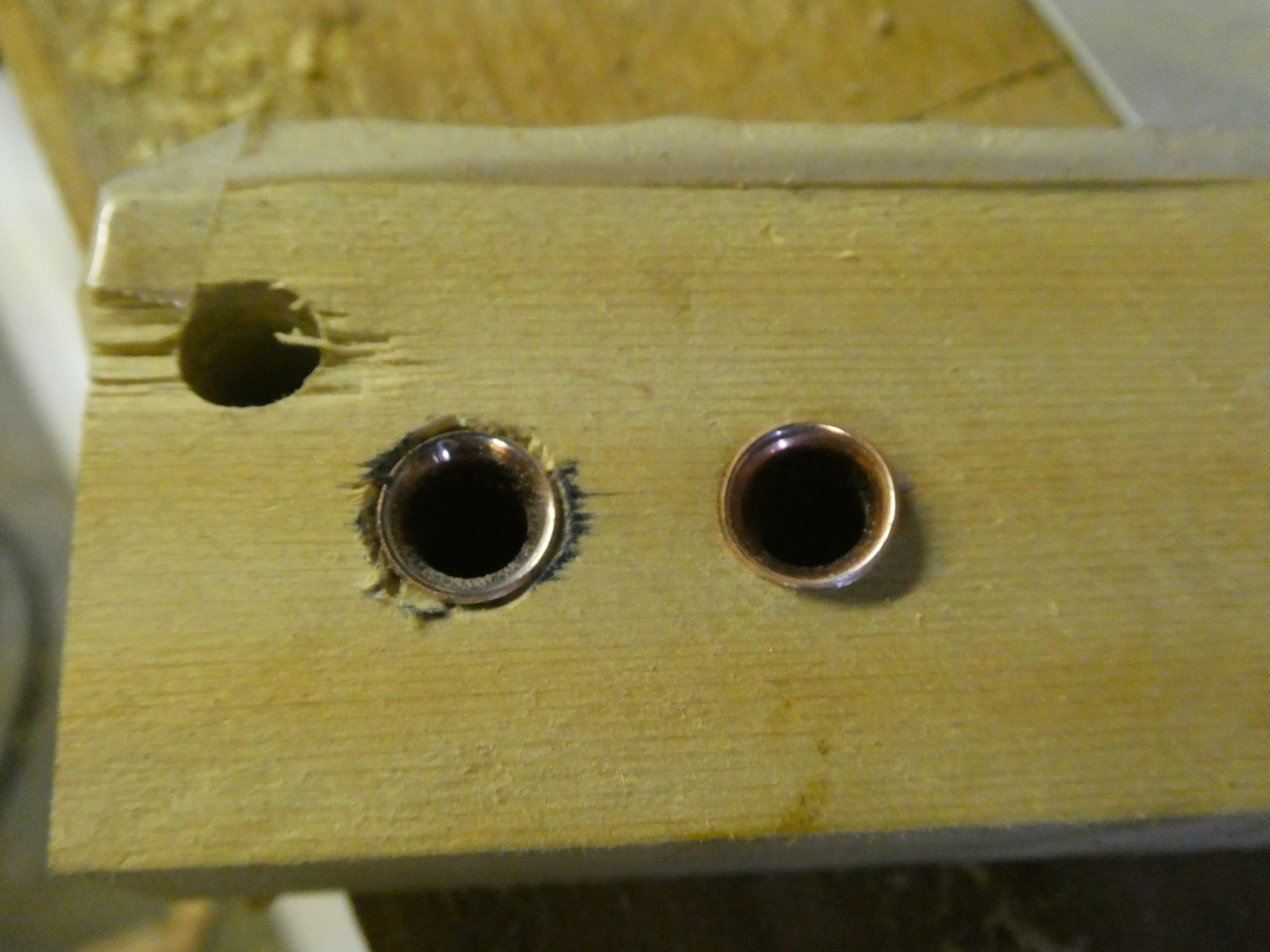 On the left, the hole is flared, on the right it's not. You can see it's quite proud on the right side