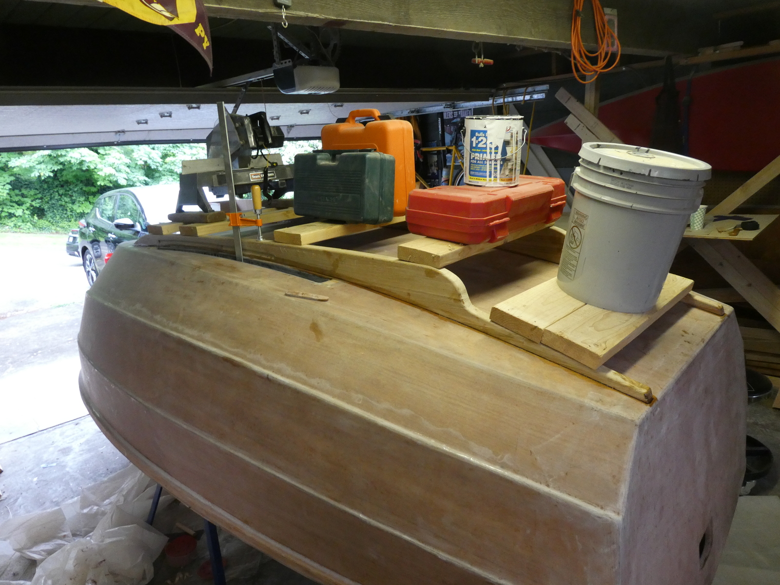 That's a mitre saw, a few tools, a gallon of paint, and a huge bucket of paint holding down the two skegs while the epoxy cures